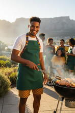 AMO Lekker Apron in Green with shweshwe print straps styled with Sun Weave shorts — Africa Made Only, Cape Town