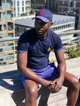 Blue t shirt with shweshwe and swim shorts and shweshwe peak cap